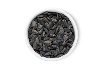 Bowl with healthy black sunflower seeds with shell isolated on white background.Top view.