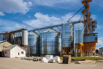 silos on agro-industrial complex with seed cleaning and drying line for grain storage. Granary elevator
