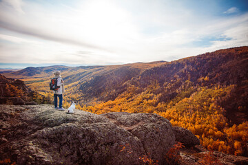 Middle Aged Woman with backpack walking in the autumn forest trip