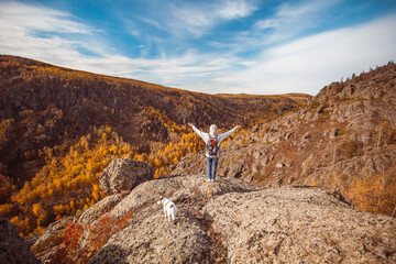 Freedom Traveler Woman with Backpack standing with Raised arms and enjoying beautiful nature