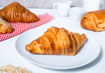 Croissant pastry on a white table. bright mood style. perfect for recipe, article, catalogue, or any commercial purposes. with copy space.