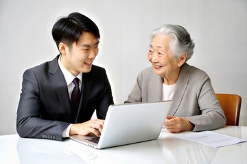 Fototapeta premium Asian Insurance Agent Assisting Elderly Customer 