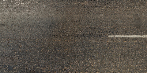 Fototapeta premium view from above on texture of asphalt road with cracks