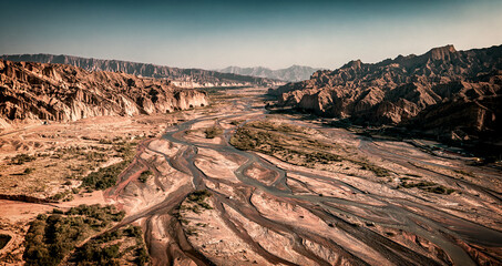 Fototapeta premium Aerial view of rivers and streams extending in desert area near Kizilya Scenic Spot in South Xinjiang, China