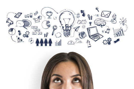 A woman looks upwards, thought bubbles with doodles above her head symbolizing ideas, on a white background, creative concept