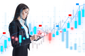 A businesswoman analyzing financial data over a graph interface, with a blurred white background indicating technology and analysis