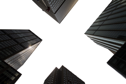 A low angle view of towering skyscrapers converging towards the sky on an overcast day