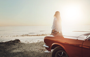 Road trip, woman and thinking with beach, sunset and view for Miami holiday and vacation. Muscle car, hood and adventure with idea, freedom and summer for driving and journey with ocean sightseeing