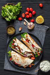 grilled chicken street tacos on a dark plate