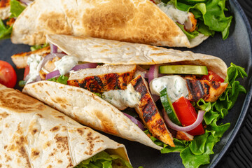 grilled chicken street tacos on a dark plate