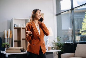 Confident business expert attractive smiling young woman holding digital tablet  on desk