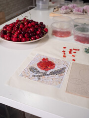 A vertical close-up flat lay captures a mosaic workshop table in all its vibrant detail.