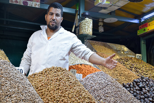 Dates, apricots, almonds and snacks displayed in business of Marrakesh square