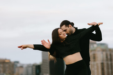 Romantic couple dancing on a rooftop in the city