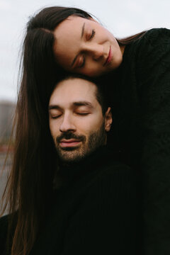 Intimate moment of a couple embracing with closed eyes