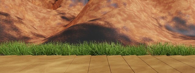 Wooden platform with green grass in front of a rocky mountain background