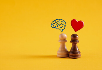 Chess pawns with human brain and heart symbols on yellow background.