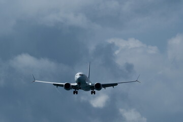 Airplane in the cloudy sky. 