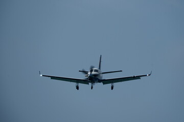Single-engined turboprop airplane in the cloudy sky.