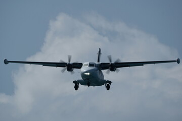 Twin-engine short-range transport aircraft in the cloudy sky.