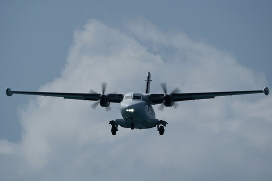 Twin-engine short-range transport aircraft in the cloudy sky.