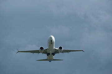 Airplane in the cloudy sky. 