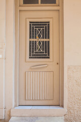 Light brown color door on the street in Greece. Travel and architecture concept
