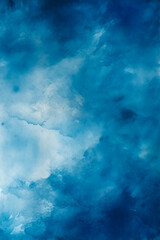 Obraz premium An abstract watercolor paint background in dark blue tones, featuring soft and smooth gradients that create a serene and calming atmosphere, with a fluid and ethereal texture.