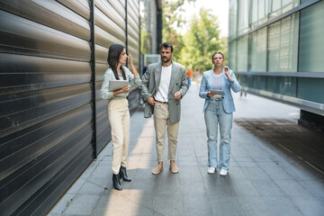 Fototapeta premium Young business people group businessman businesswoman walk from office building to building between meetings they train employees to better and more successful work in corporation and presentation