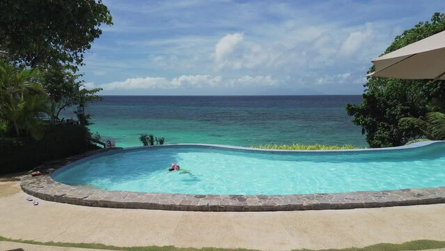 anda, bohol, philippines. private beach resort in anda bohol. beach front with white beach and crystal clear blue water, with a very big swimming pool, suitable for family vacationing in the place