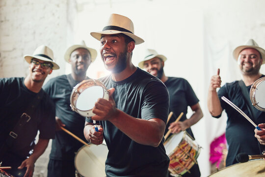 Drums, performance and man at carnival for sound, creativity and art for show. Band, Brazilian singer and happy or dancing for festival, celebration and community or culture for event or party