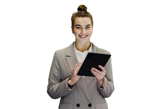 A successful businesswoman is seen using a tablet computer while wearing glasses and a business jacket. The background has been removed.

