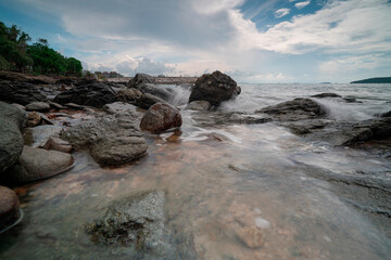 Rocks by the sea and rain clouds