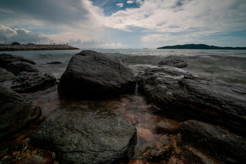 Rocks by the sea and rain clouds