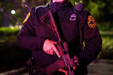 Police officer, night and body of person with gun for law enforcement, protection and...