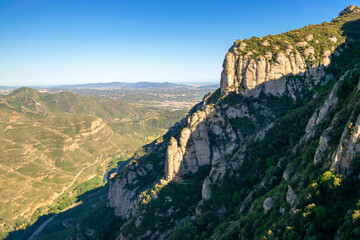 The evening sunlight illuminates the highest peaks of Montserrat mountain in Catalonia
