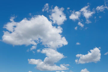 abstract background of white fluffy clouds on a bright blue sky