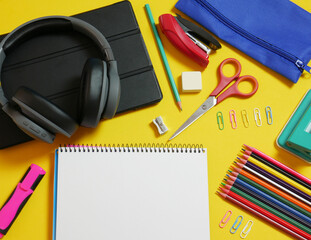 Zenith view. Back to school, supplies, various accessories in full color, yellow background and copy space.
