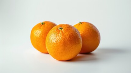 Fresh whole oranges isolated on a clean white background. Perfect for natural food concepts.