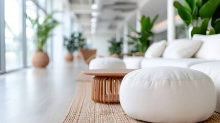 A contemporary lounge area featuring white furniture and lush green plants. The soft lighting and natural elements create a serene and inviting atmosphere for relaxation.