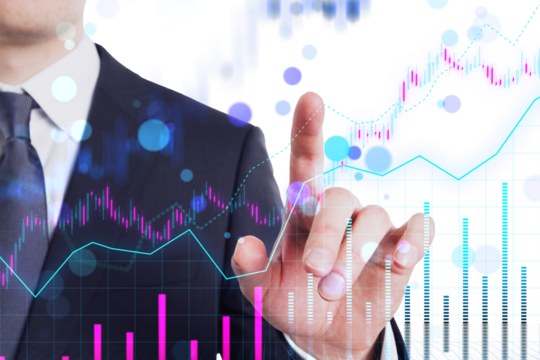 A businessman using a virtual interface with financial graphs, on a blurred background illustrating data analysis or stock market trends