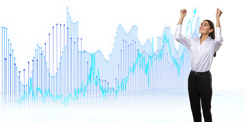 A businesswoman celebrating success against a backdrop of digital financial growth charts on a...