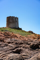 Isola Rossa historic tower at sunset in Sardinia, Italy