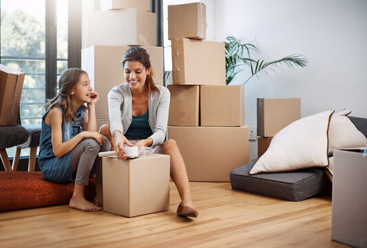 Mother, daughter and packing boxes to new home for moving, mortgage investment and property relocation with bonding. Woman, child and happy with tape for cardboard package or real estate in apartment