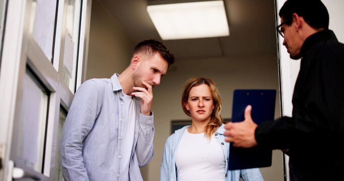 Bailiff speaking to a distressed couple