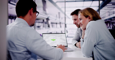 Male Real Estate Broker Explaining Development Plan To Young Couple