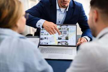 Professional Real Estate Agent Presenting Property Options to Happy Couple
