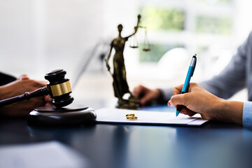 Young couple, one Caucasian and one Hispanic, consulting with a lawyer in court