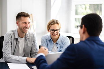 young couple is meeting with a financial planner