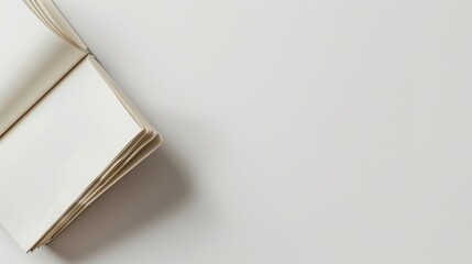 Open Blank Notebook on White Surface
